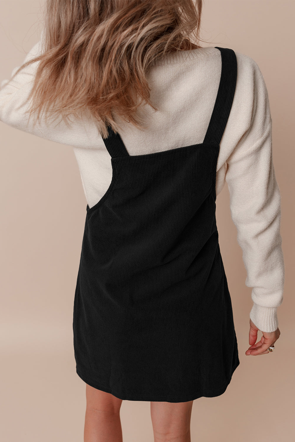 Chic black sleeveless corduroy overall dress with front pockets