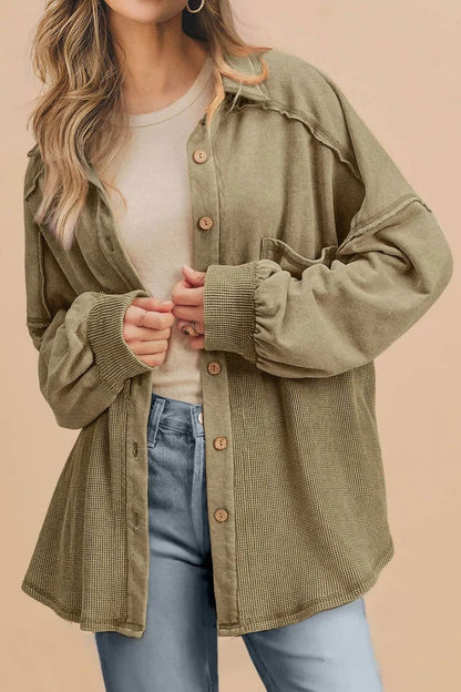 Waffle-knit collared shacket in olive green with button-up front and exposed seams.