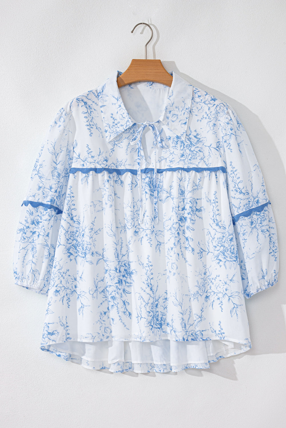 Chic sky blue floral blouse with tied collar and 3/4 sleeves