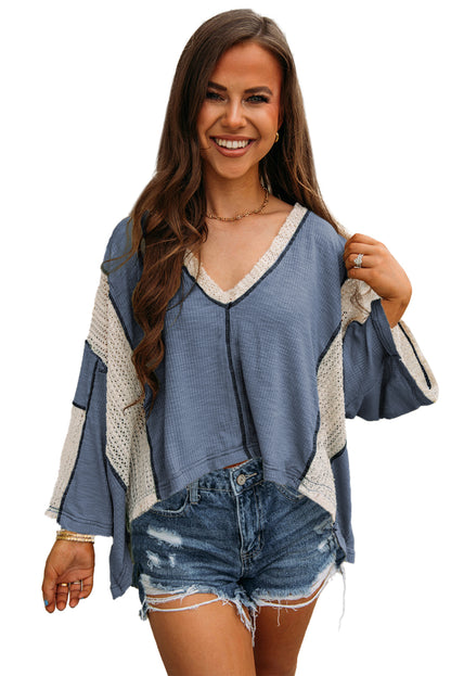 Ashleigh blue high-low loose top with crochet accents and exposed seams