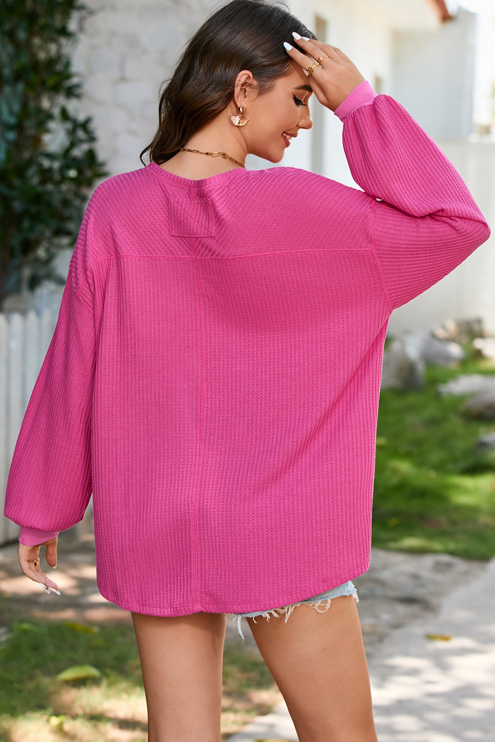 Chic bright pink waffle knit V-neck blouse with drop shoulders