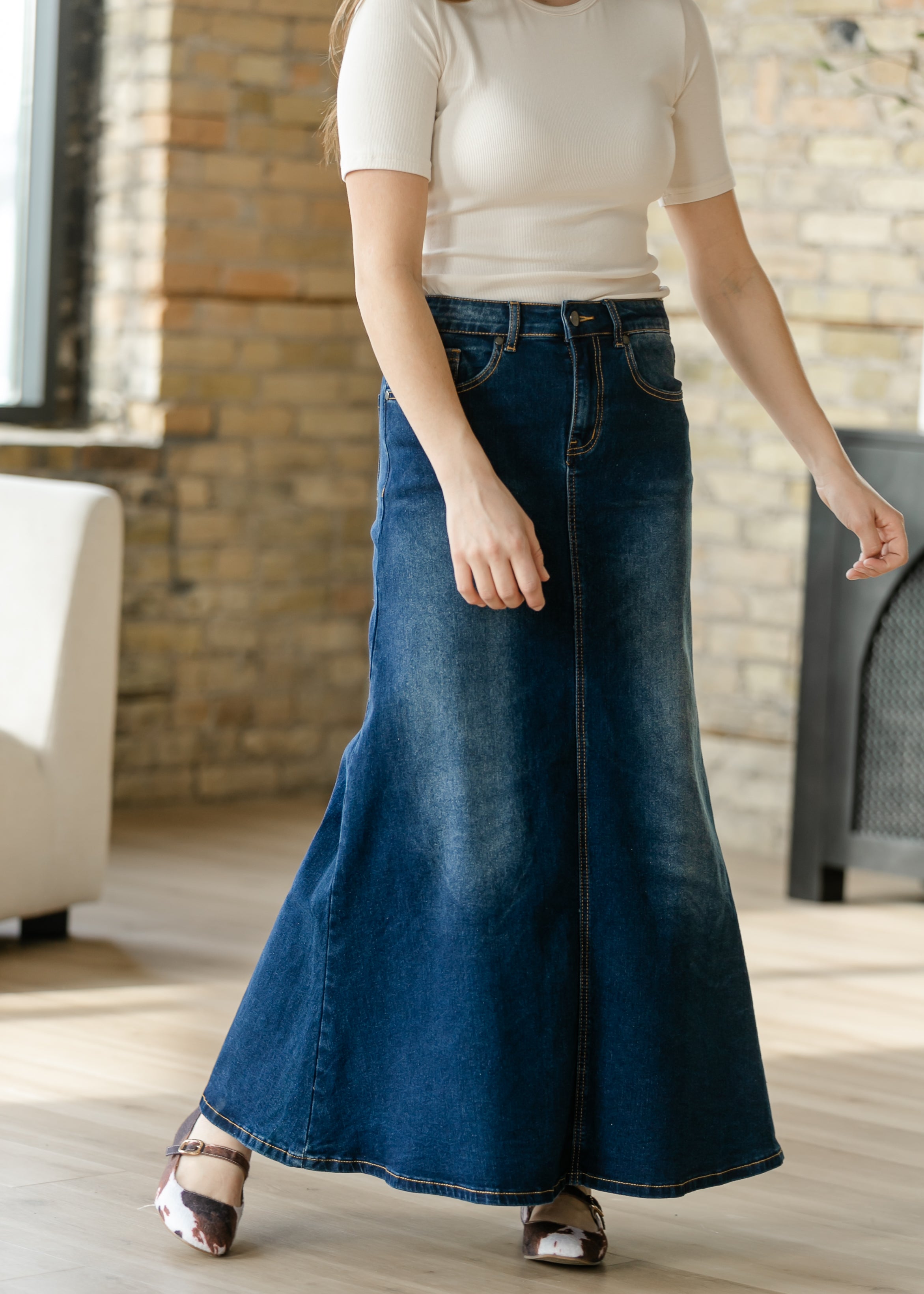 Rear view of the Inherit Co. Bethany Dark Wash A-line Long Denim Skirt, showing its graceful flow and modest coverage.