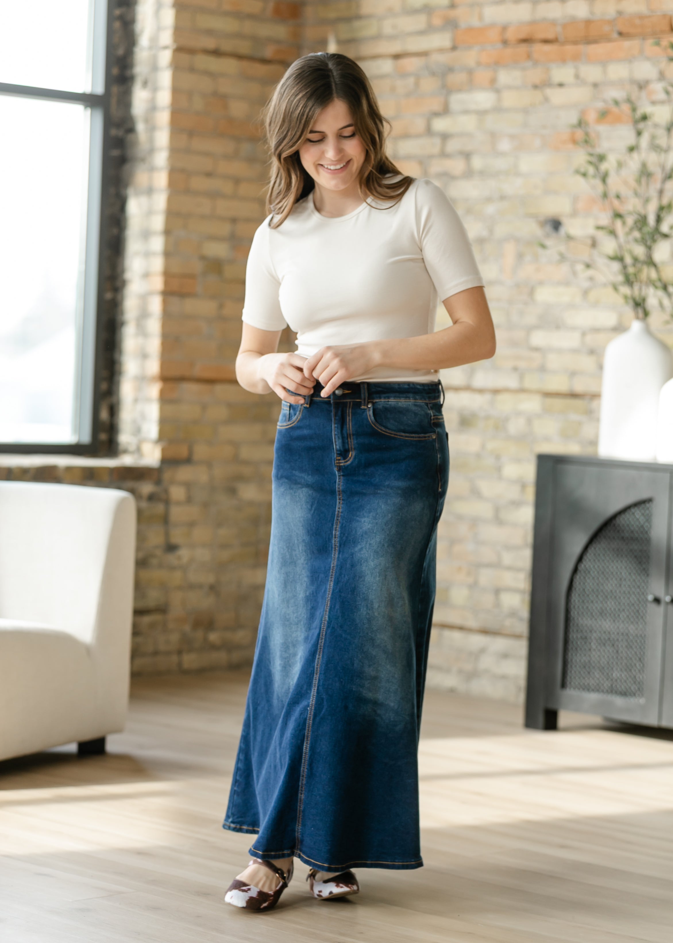 Detailed view of the rich dark wash denim fabric and durable stitching on the Inherit Co. Bethany A-line Long Skirt.