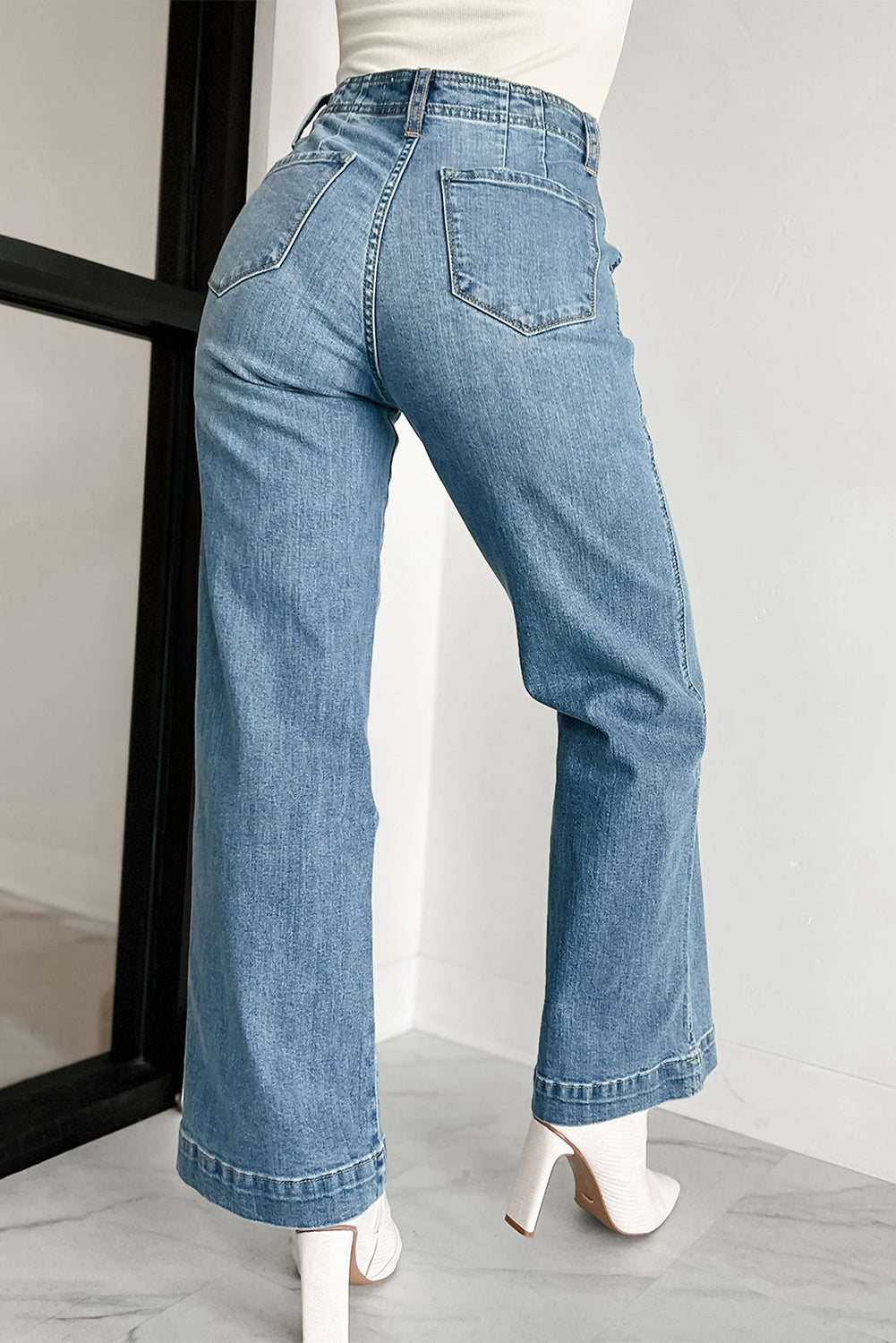 Dusk blue high-waisted loose leg jeans with unique button details