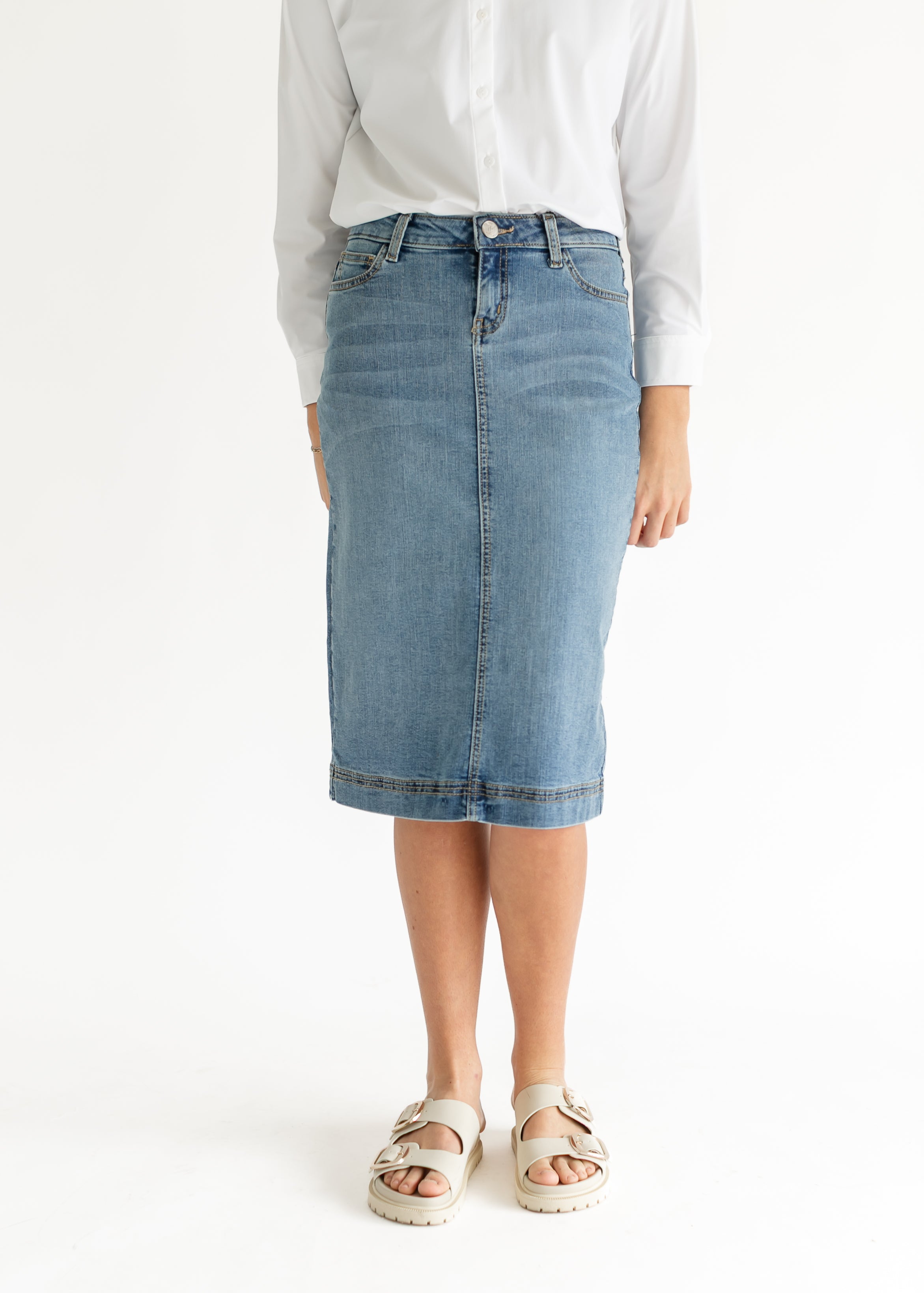 Detail shot of the Inherit Co. Bryn Light Wash Denim Midi Skirt's A-line hem and durable stitching.