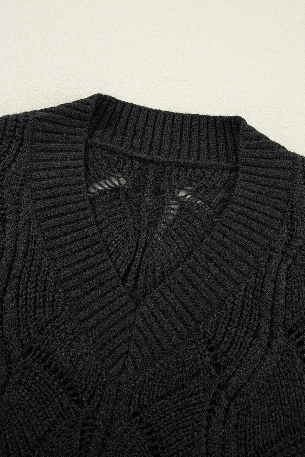 Chic black hollow knit V-neck sweater with drop shoulders