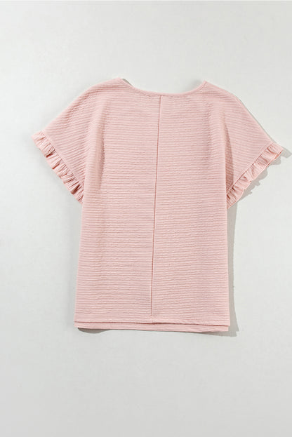 Chic light pink ruffled short sleeve blouse with textured elegance