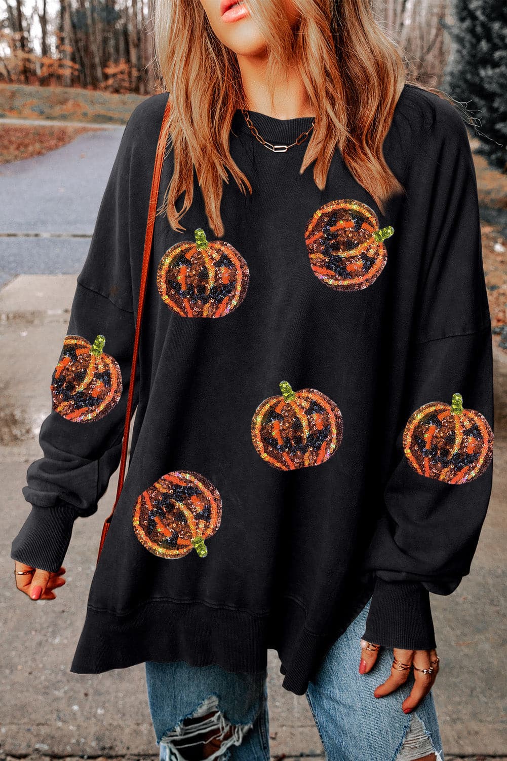 Sequin pumpkin oversized sweatshirt with slit design, featuring a black base and colorful sequin pumpkin patterns.