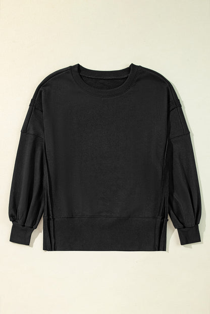 Chic black drop shoulder sweatshirt with exposed seams and side slits