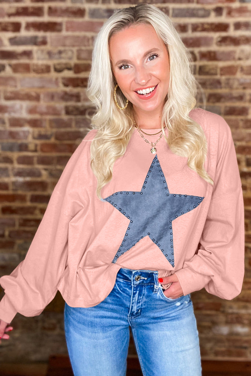 Celestial chic: Gossamer pink oversized long sleeve top with star graphic and studs