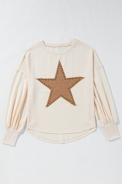 Apricot oversized long sleeve top with star graphic and beaded detail.