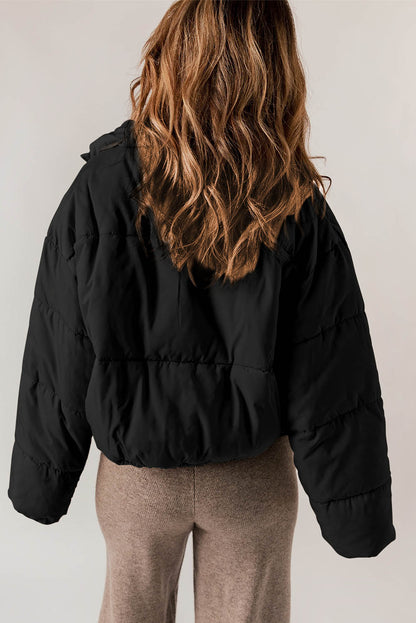 Sleek black puffer coat with zip closure and drawstring hem