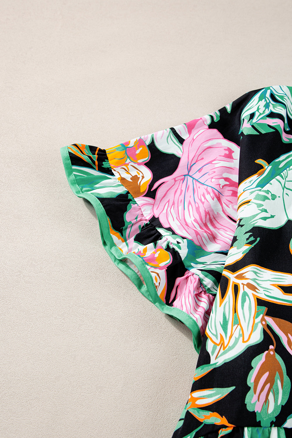 Elegant black tropical print blouse with ruffled sleeves and flowy design