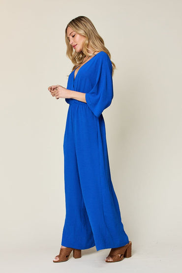 Double Take Full Size Surplice Wide Leg Jumpsuit with Pockets.