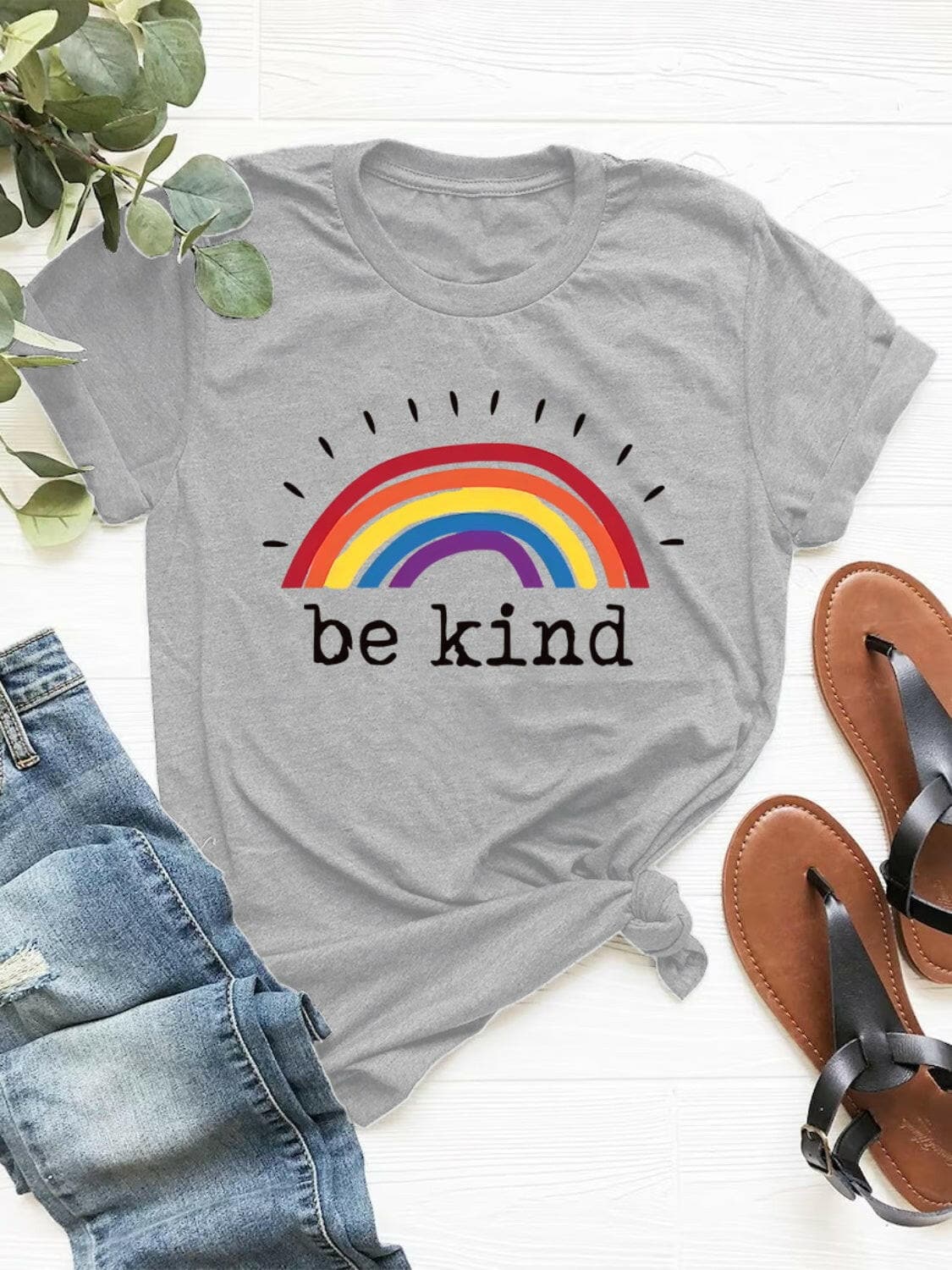 Women's graphic round neck short sleeve t-shirt with "be kind" rainbow design.