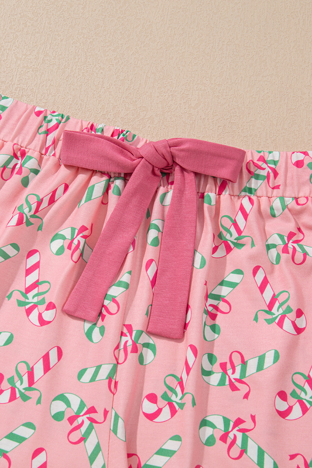 Festive pink candy cane print knotted pajama set with pockets