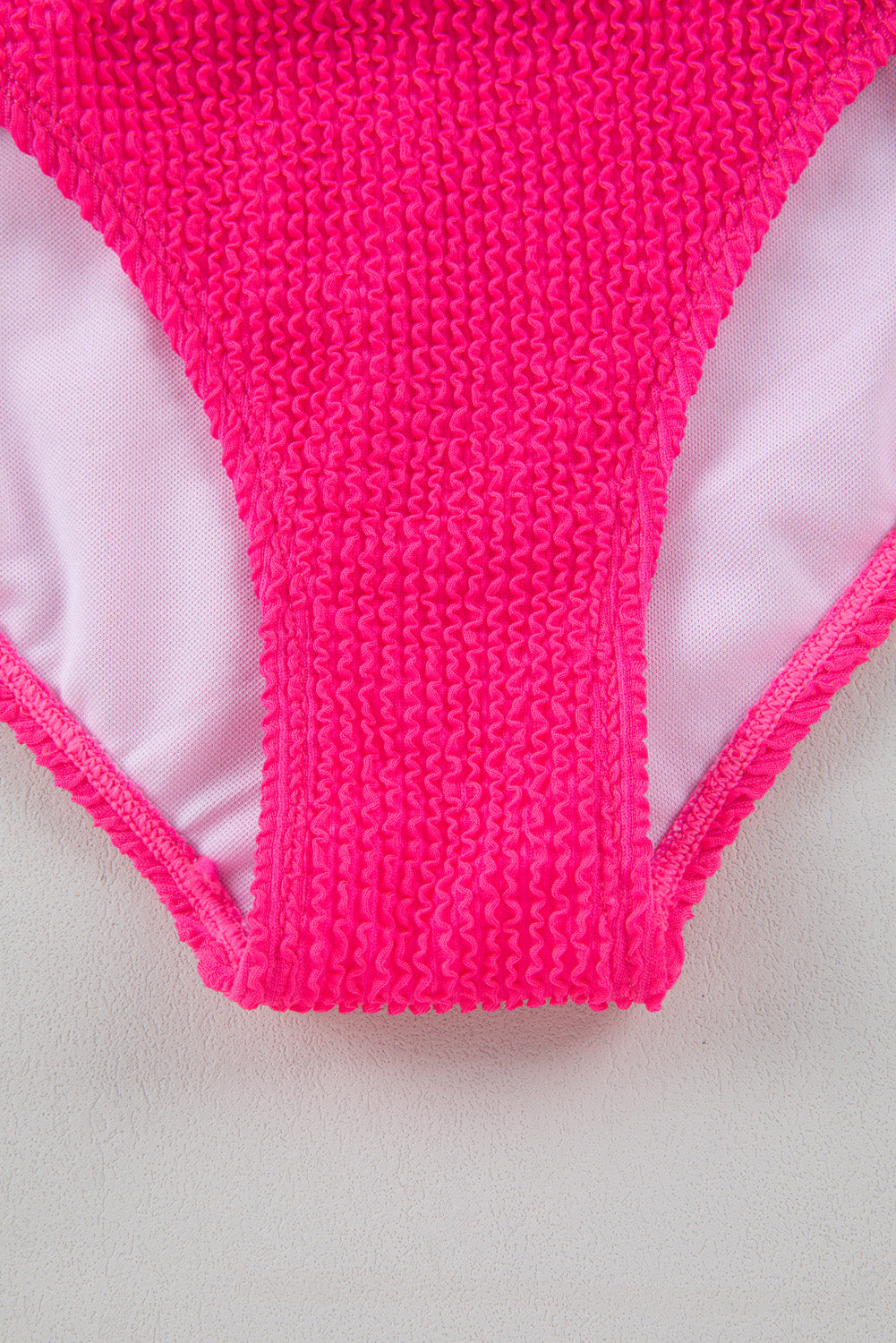 Bold bright pink textured one-shoulder monokini with cut-out design