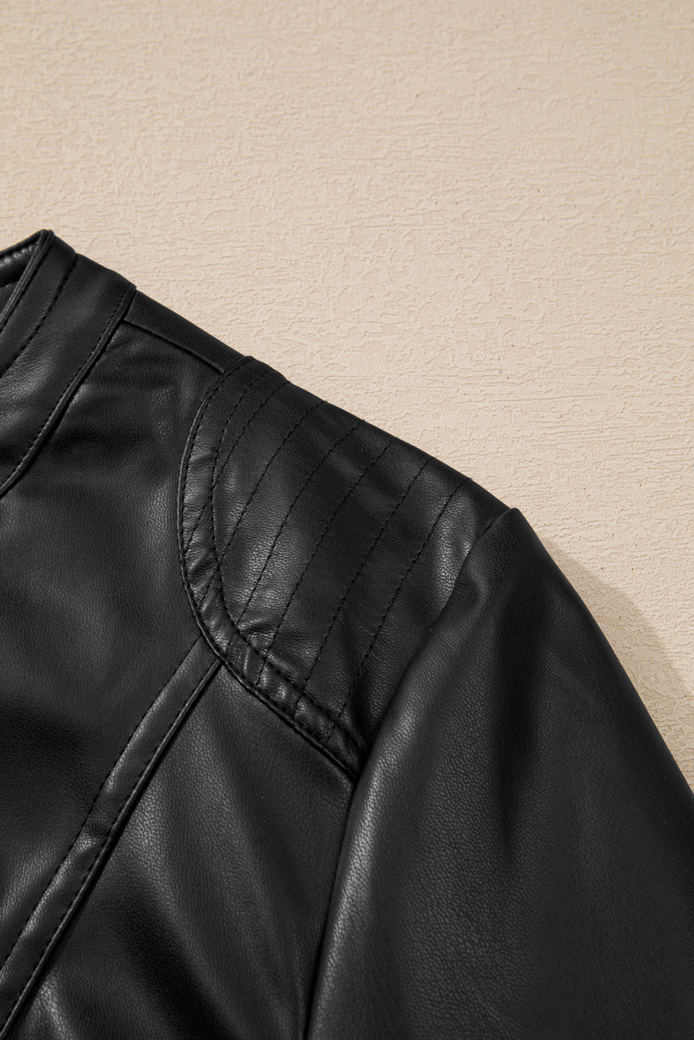 Sleek black faux leather bomber jacket with trendy zipper details