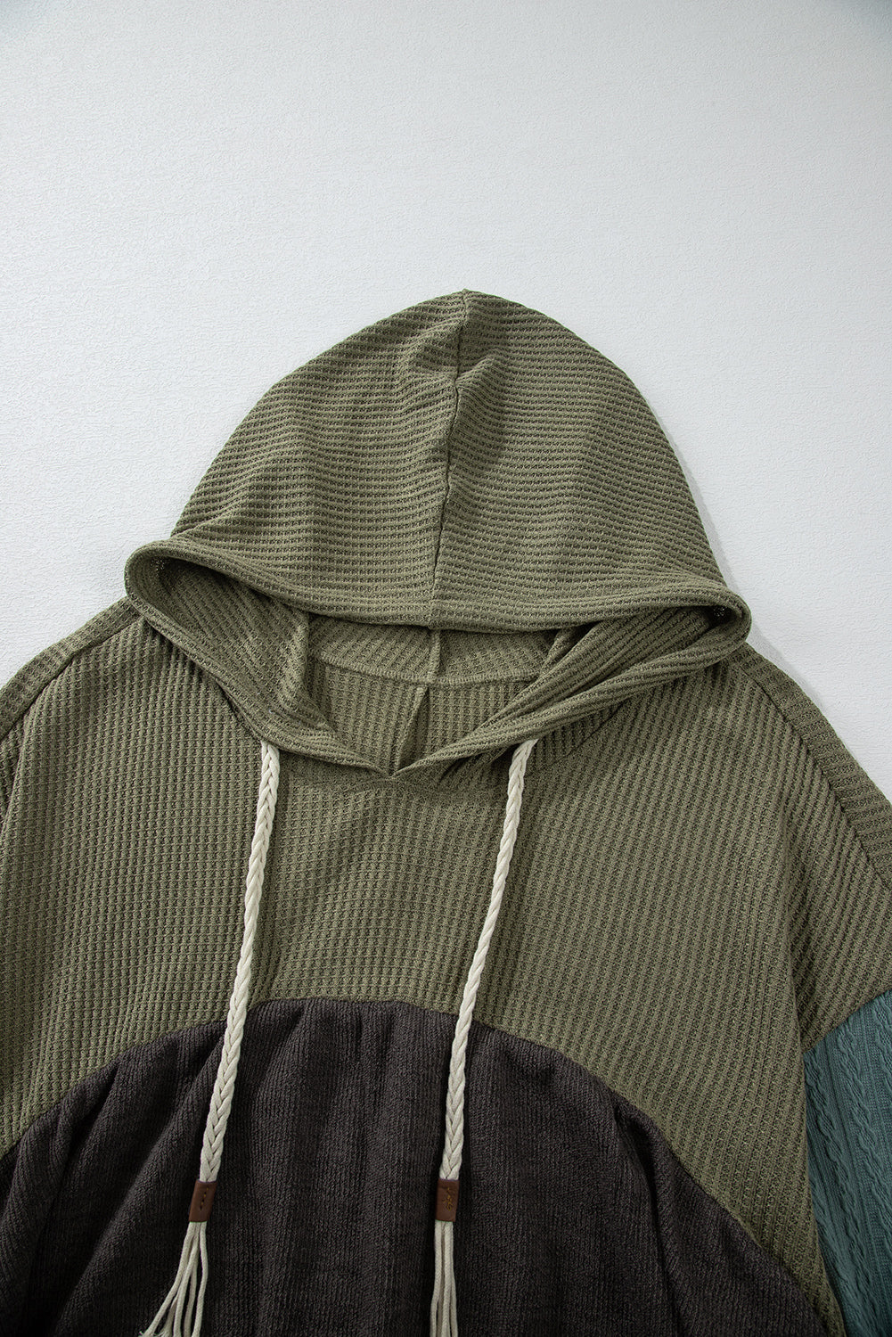 Laurel green colorblock patchwork hooded top with frayed high-low hem