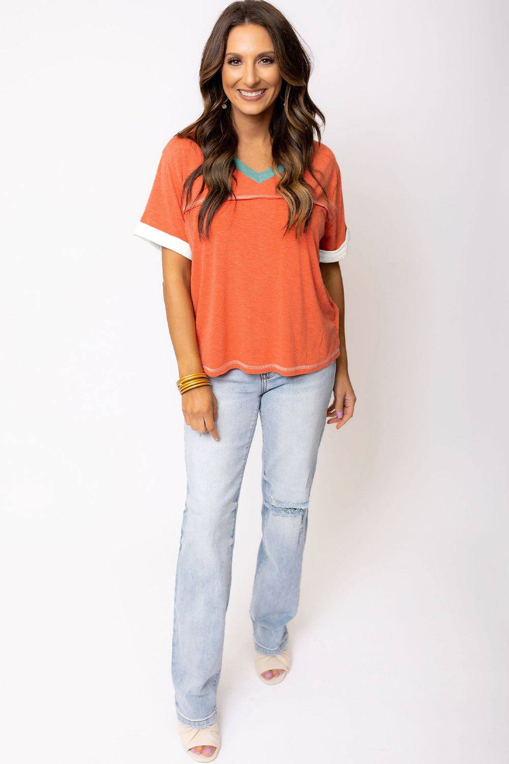 Grapefruit orange exposed seam V-neck tee with contrast trim