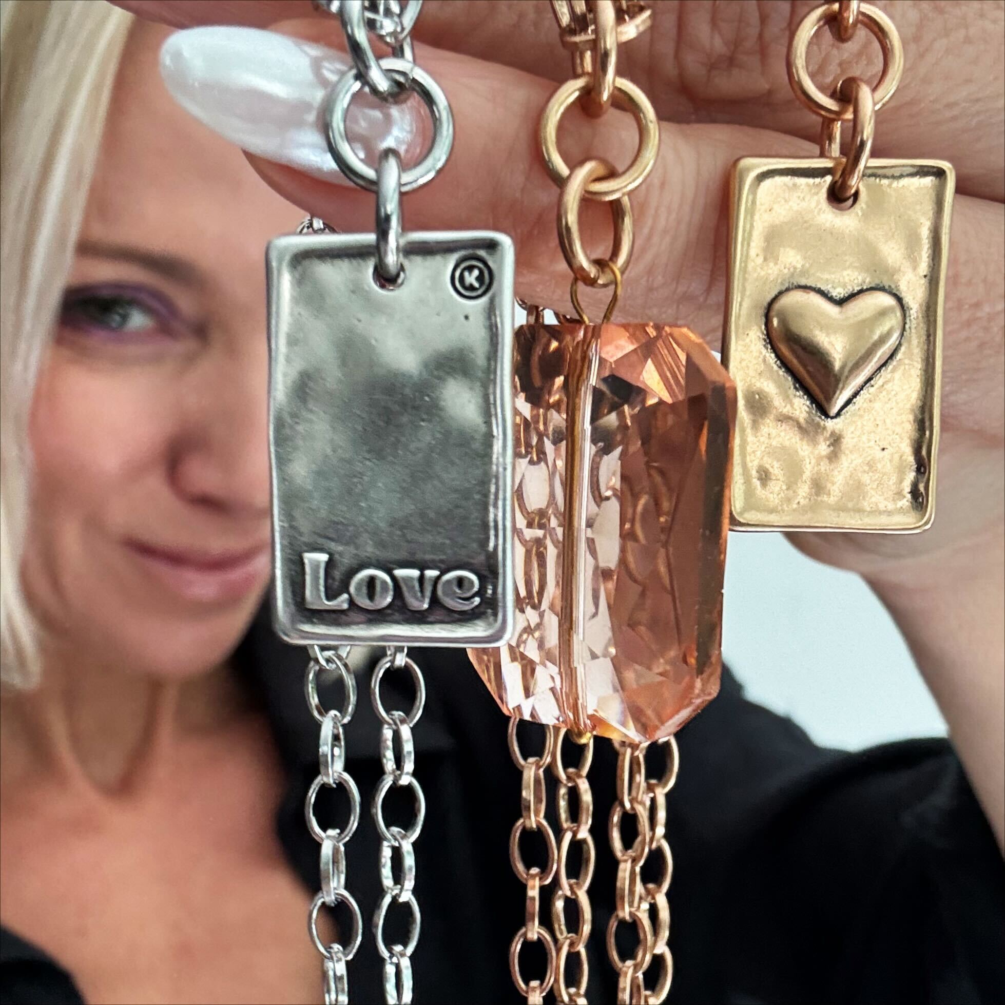 The Katia Designs Love Heart Original Lite Necklace resting on a surface, emphasizing its polished silver and minimalist style.