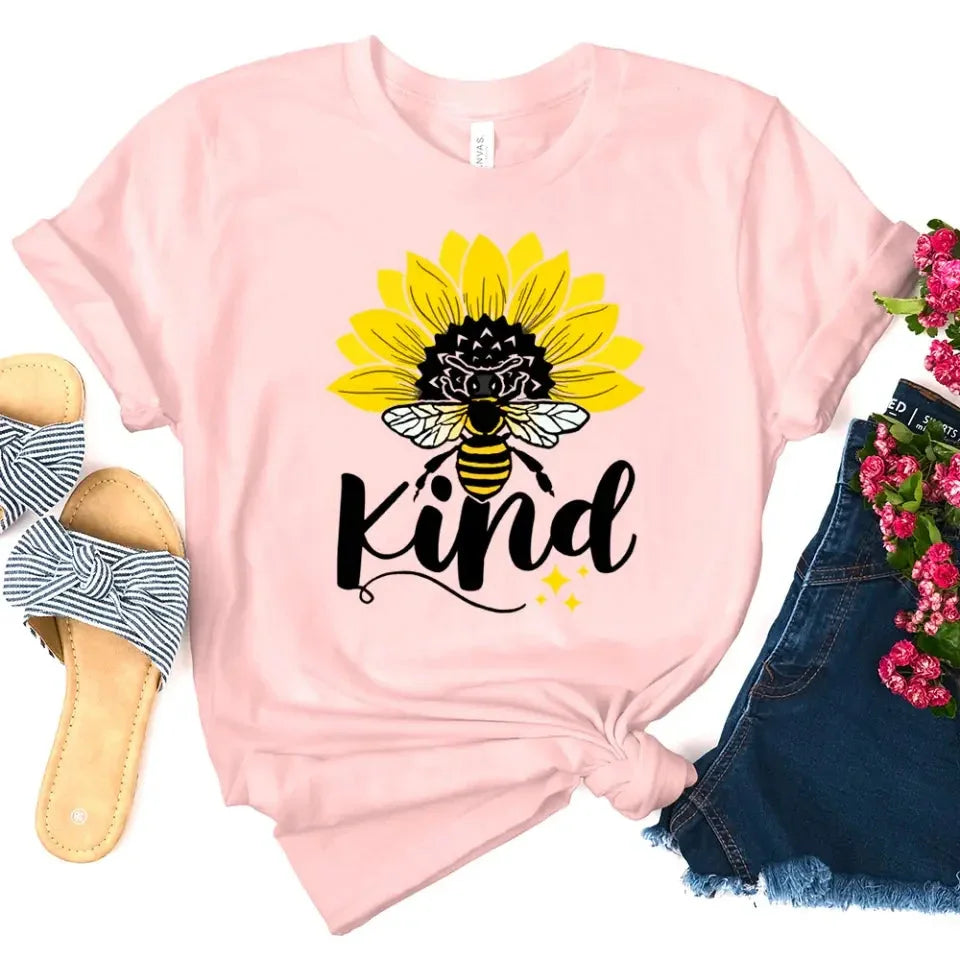 Adorb.co Bee Kind Sunflower Graphic Tee, a model showcasing the comfortable drape and positive message of this unisex shirt.