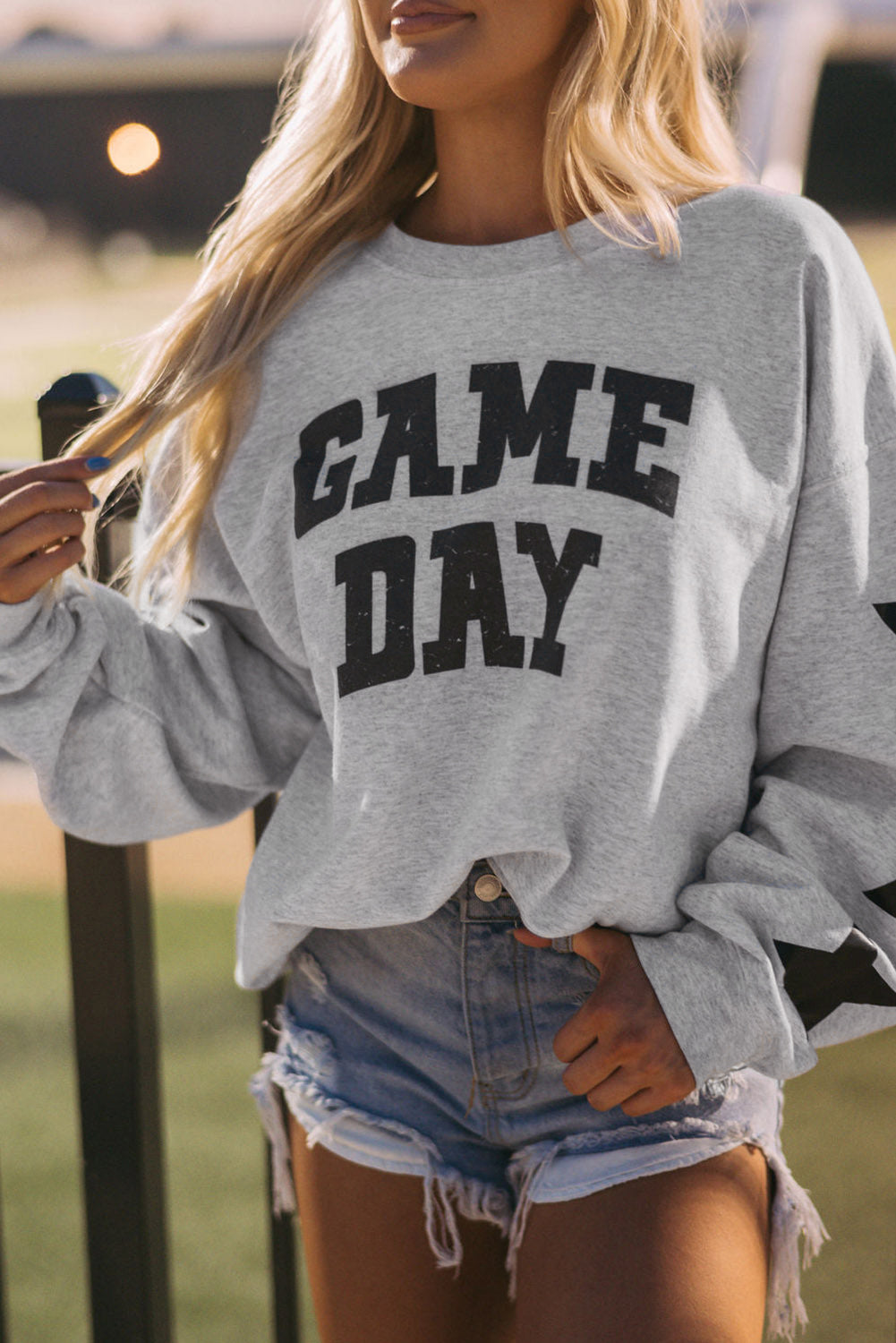 Black Game Day Graphic Rugby Football Season Sweatshirt with relaxed fit and ribbed cuffs.