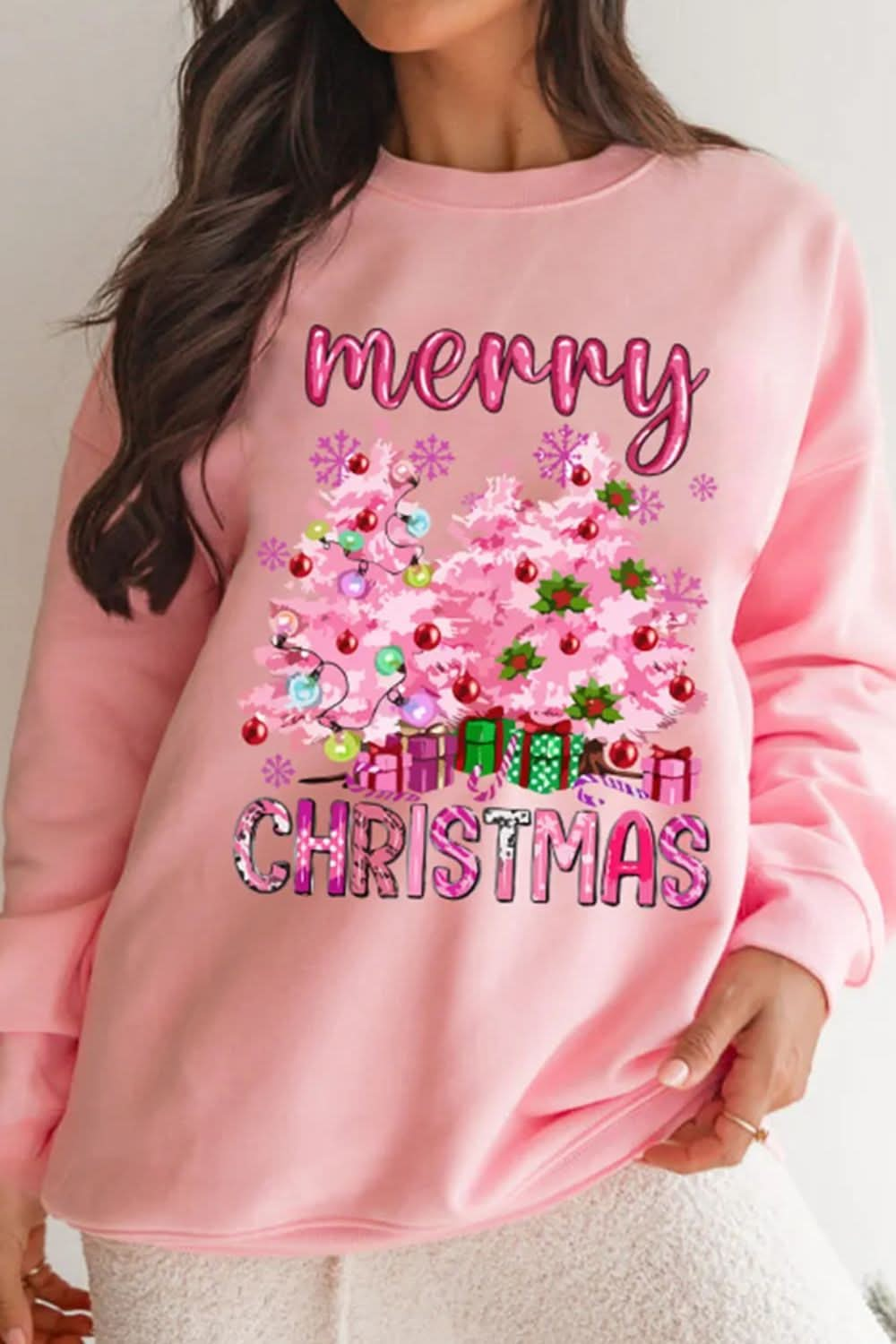 Pink long sleeve sweatshirt with "Merry Christmas" design and festive decorations.