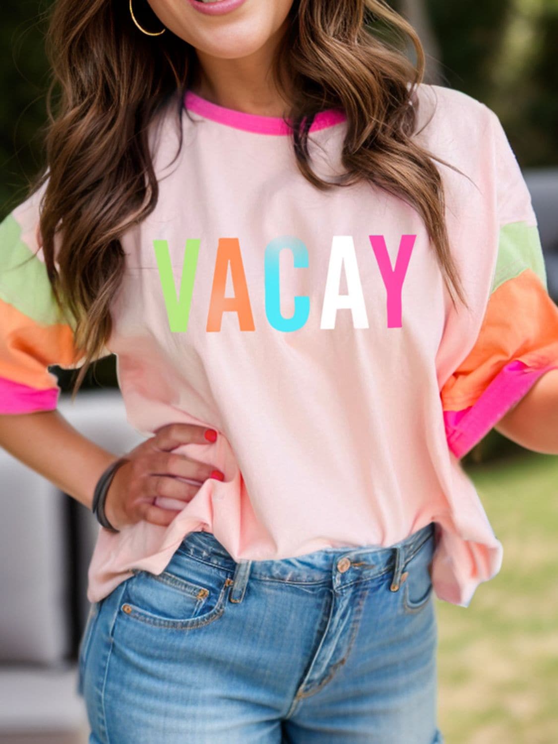 Chic color block letter graphic tee with 'VACAY' text, casual style.