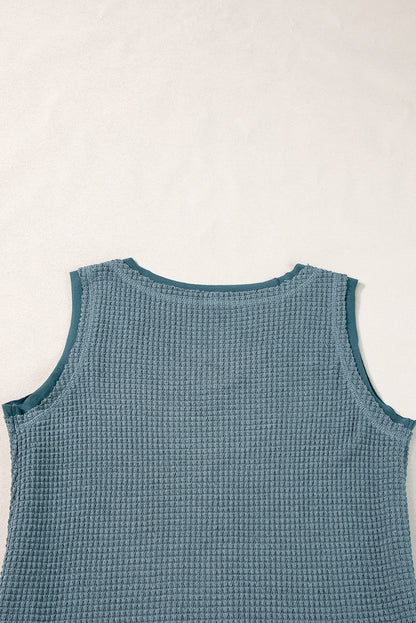 Teal flowy vest with scoop neckline and waffle knit texture