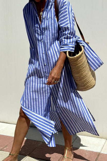 Chic button-up dress with sleeves in blue and white stripes, perfect for casual or formal occasions.