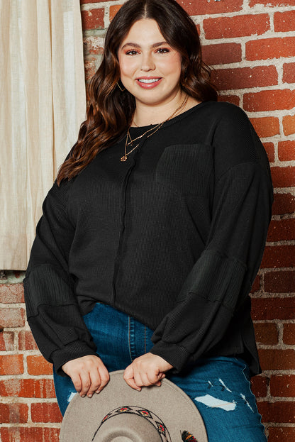 Chic black crinkle patchwork top in plus sizes with exposed seams