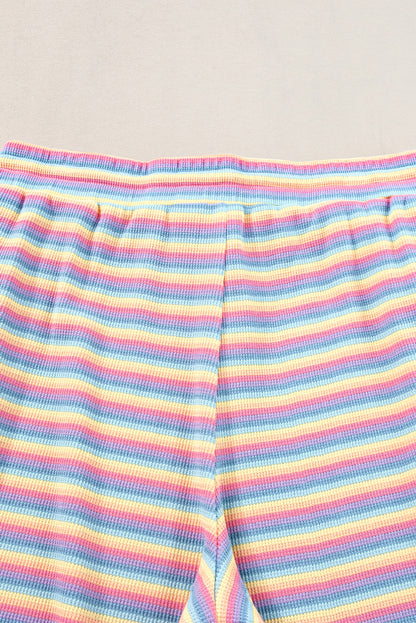 Chic pink striped rainbow tee and tasseled wide leg pants ensemble