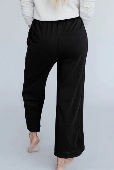 Trendy black wide leg pants with mineral wash and exposed seam details