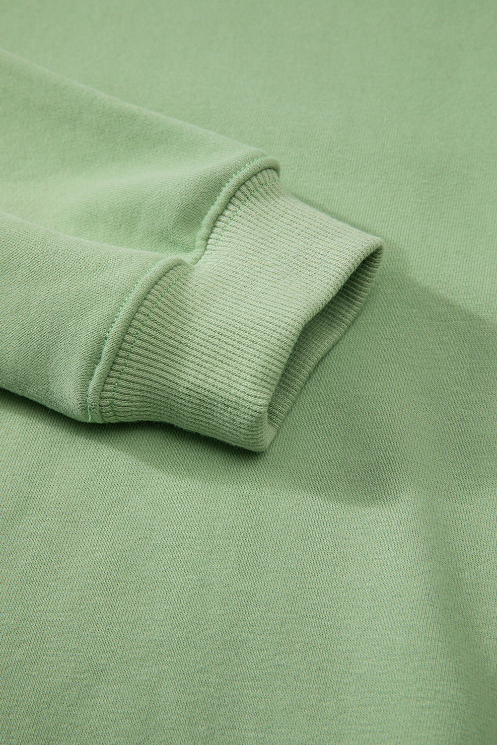 Cozy smoke green fleece-lined sweatshirt with drop shoulder design