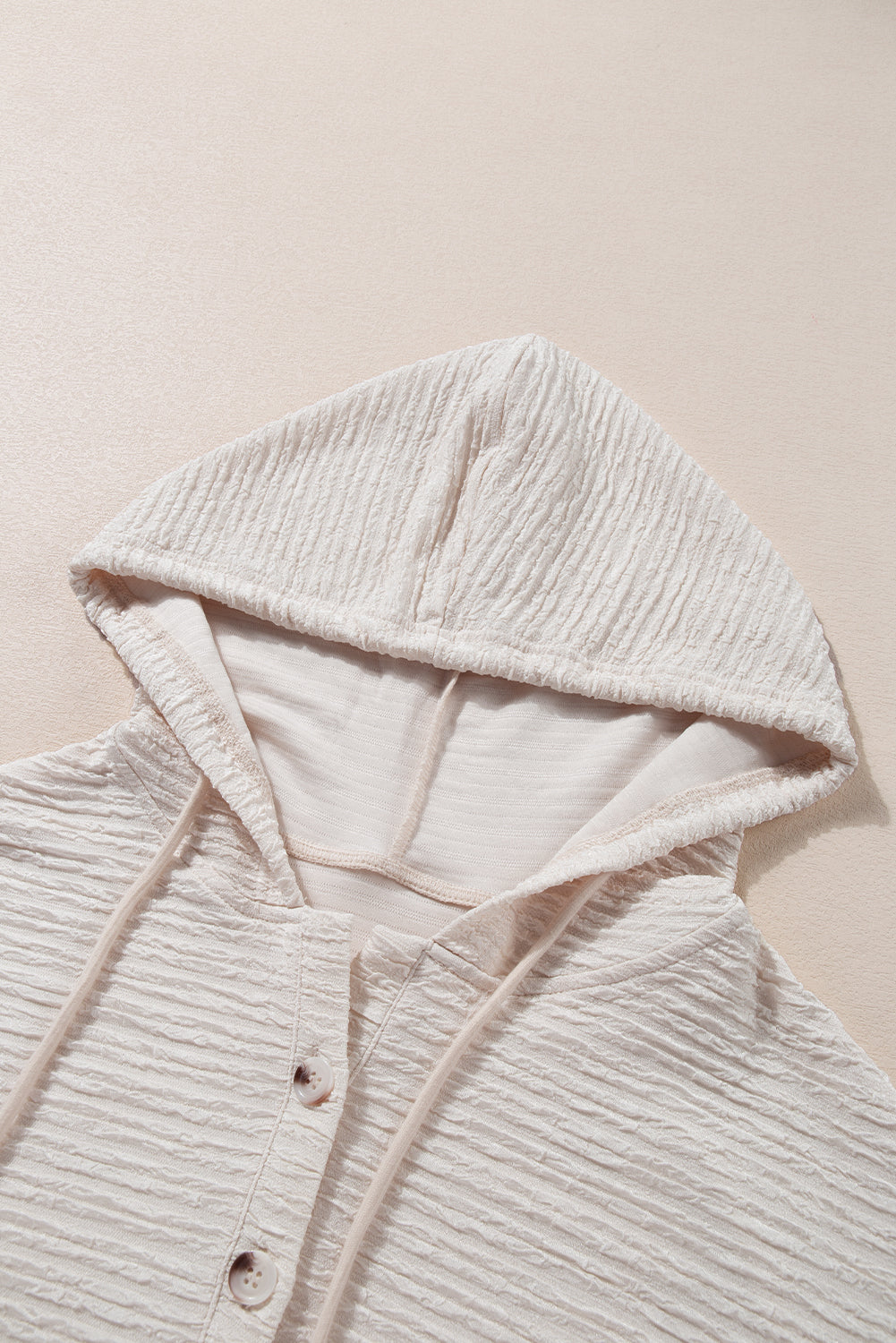 Apricot textured drawstring hoodie with buttoned neckline