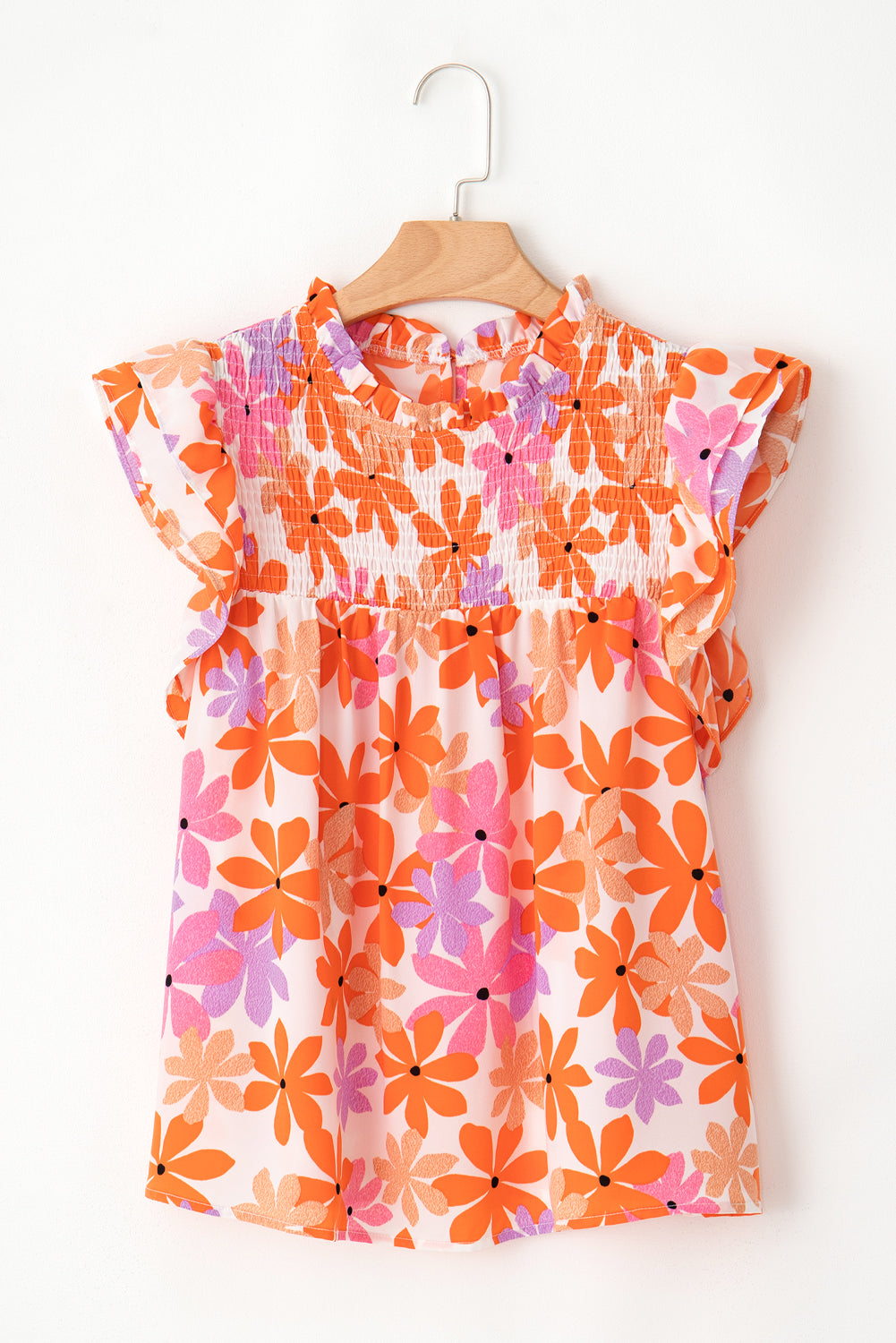 Floral delight: Orange ruffled sleeve top with smocked detail