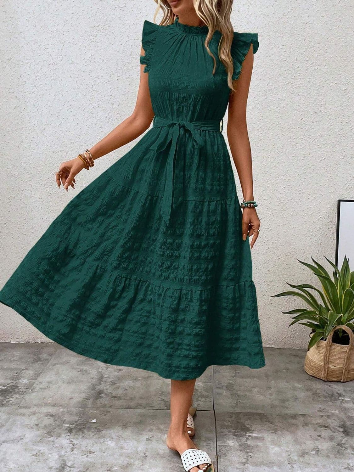 Ruffled cap sleeve midi dress in green with tied waist and tiered skirt.