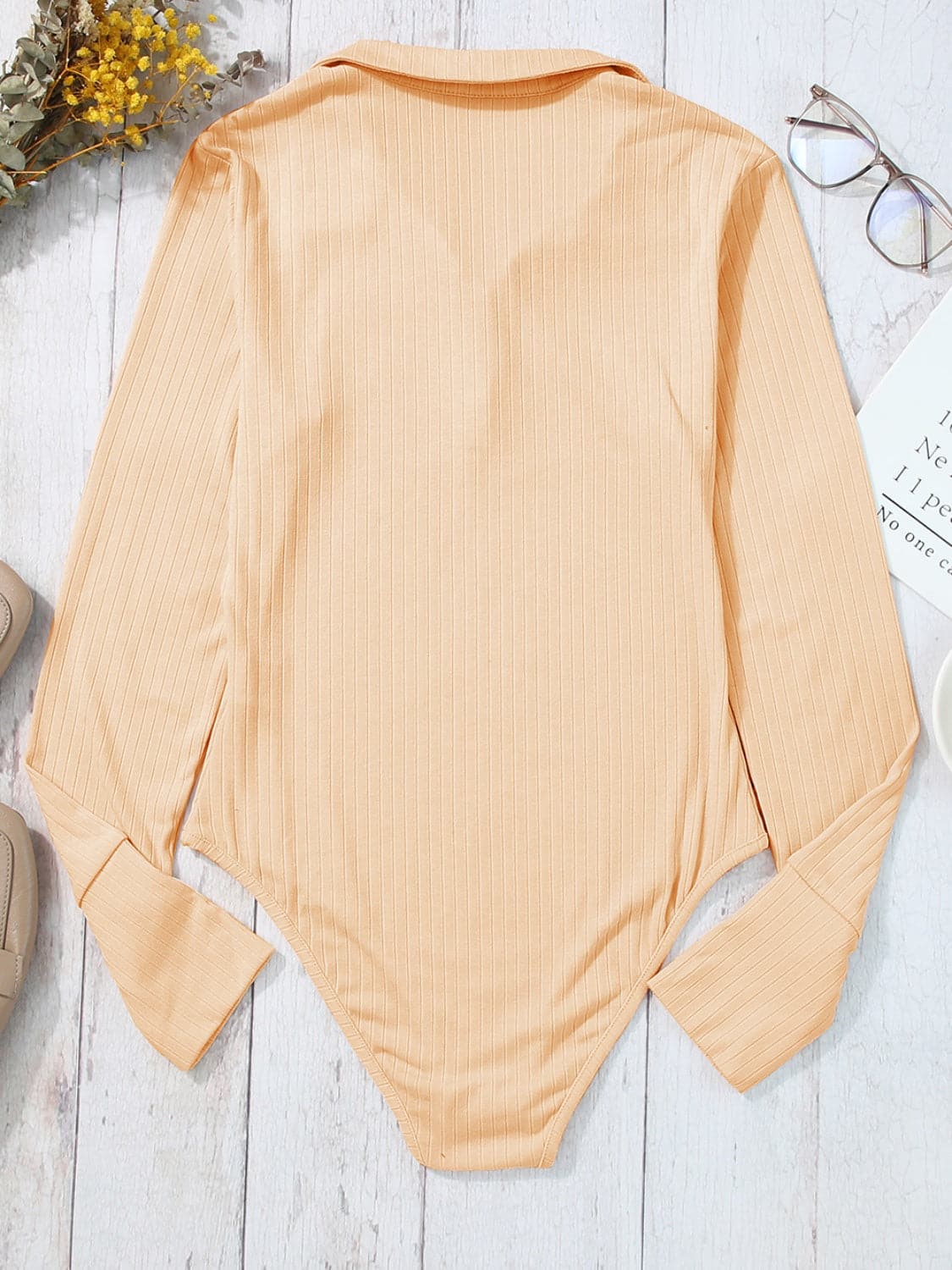 Half Button Collared Neck Long Sleeve Bodysuit.