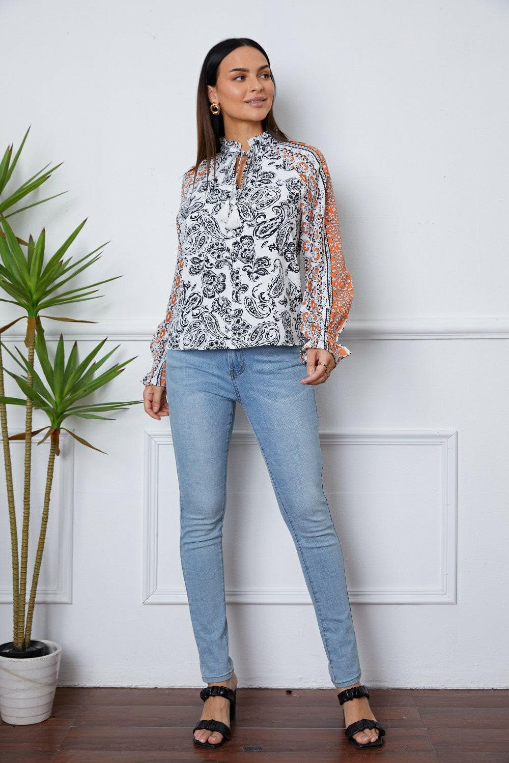 Tassel Tie Neck Printed Smocked Long Sleeve Blouse.