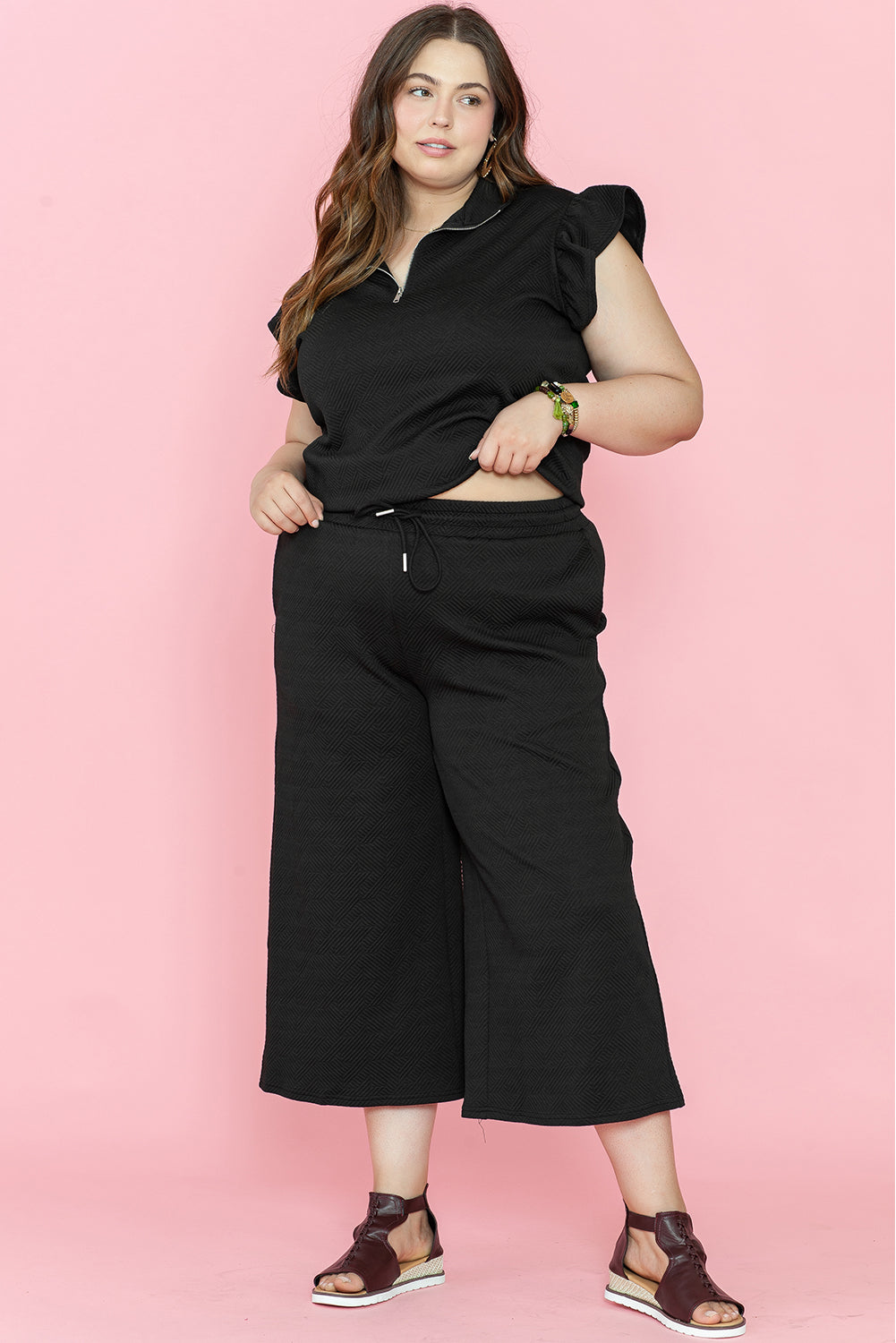 Chic black plus size ruffled sleeve quarter zip top and wide-leg pants set