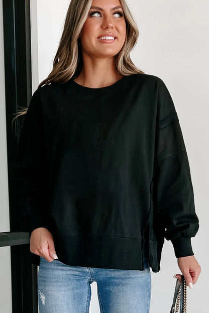 Chic black drop shoulder sweatshirt with exposed seams and side slits