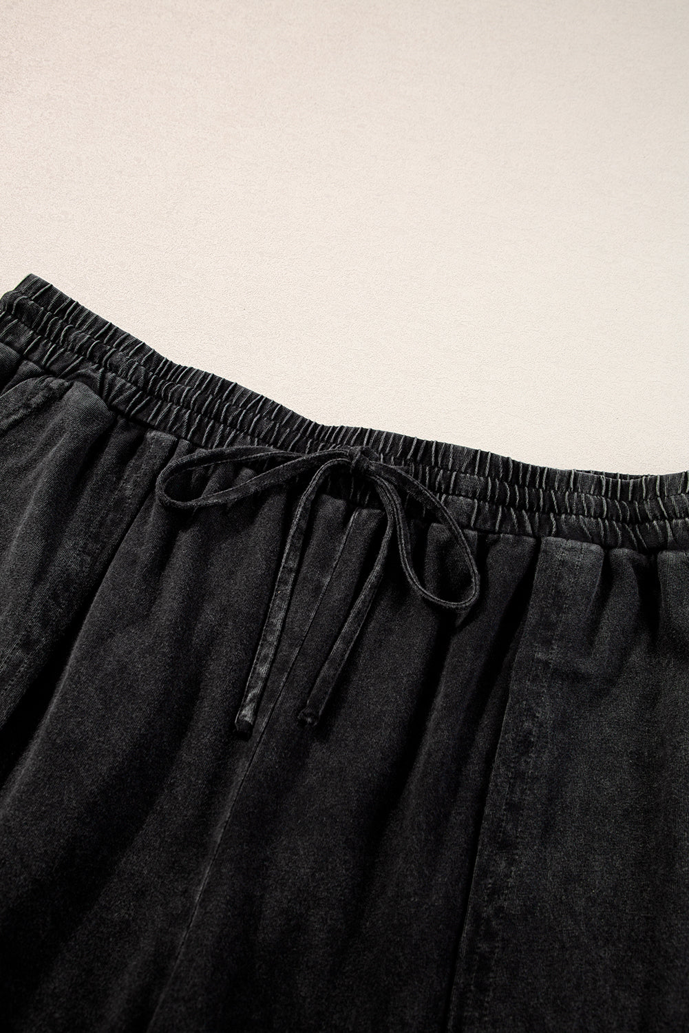 Chic black mineral wash wide leg cropped pants with exposed seams