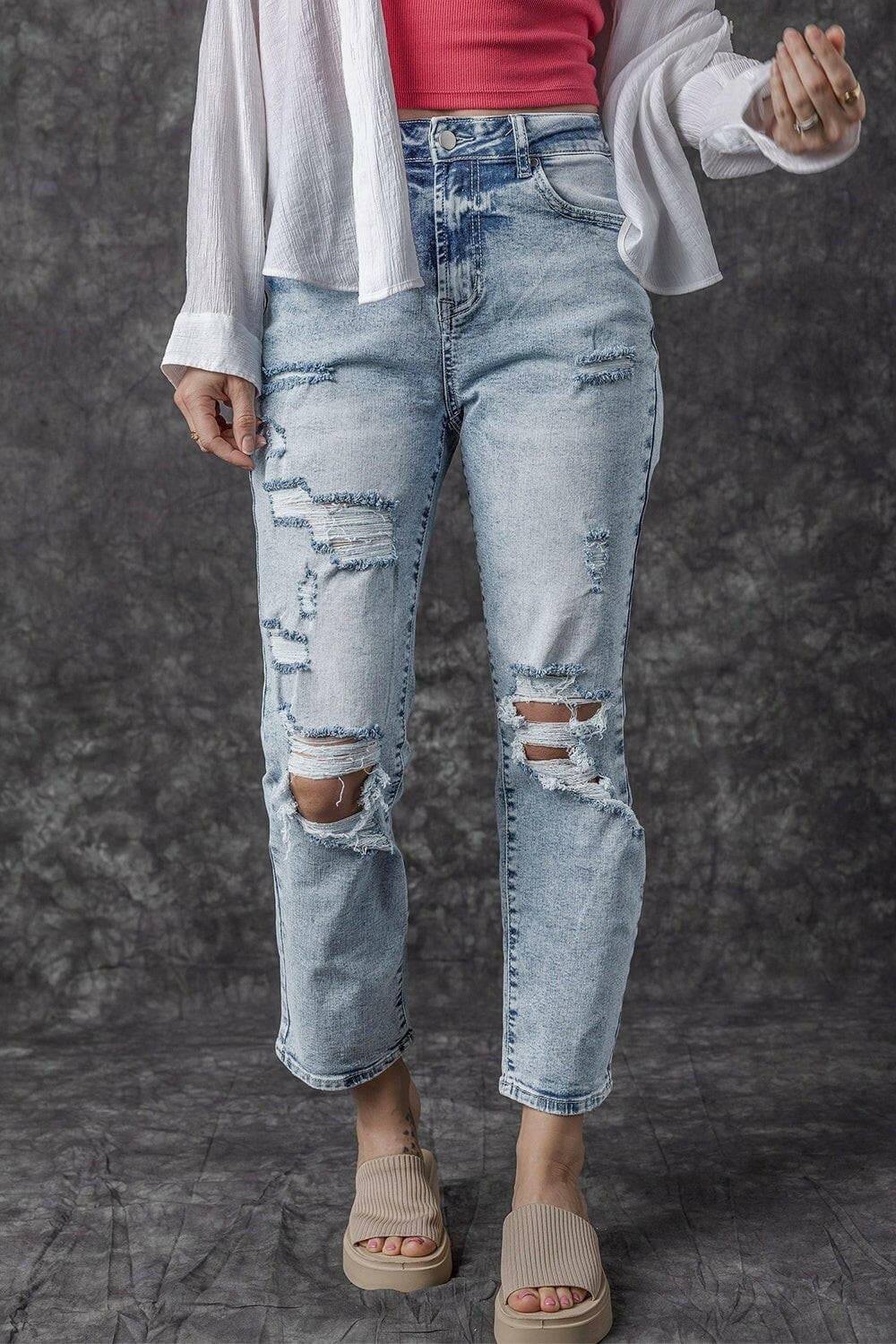 Rugged chic high rise denim jeans with distressed detailing and trendy silhouette.