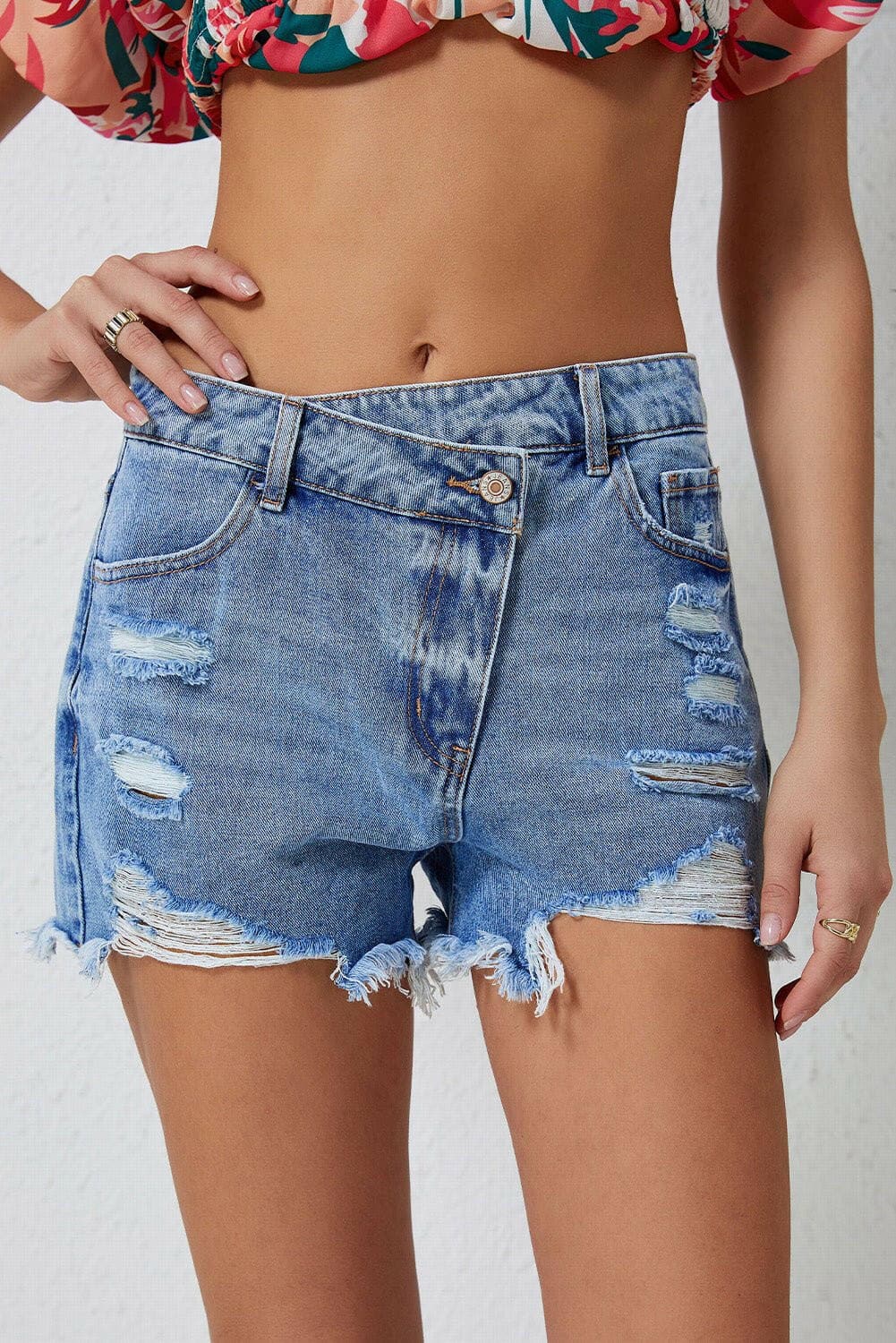 Trendy distressed denim shorts with raw hem and edgy detailing.