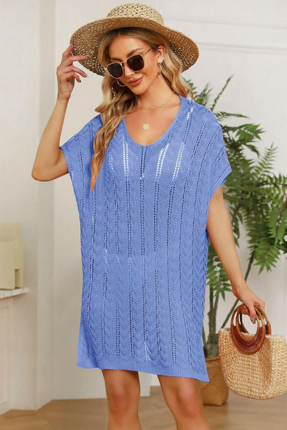 Elegant knit cover up with slits featuring an openwork design in blue, worn by a woman with a hat.