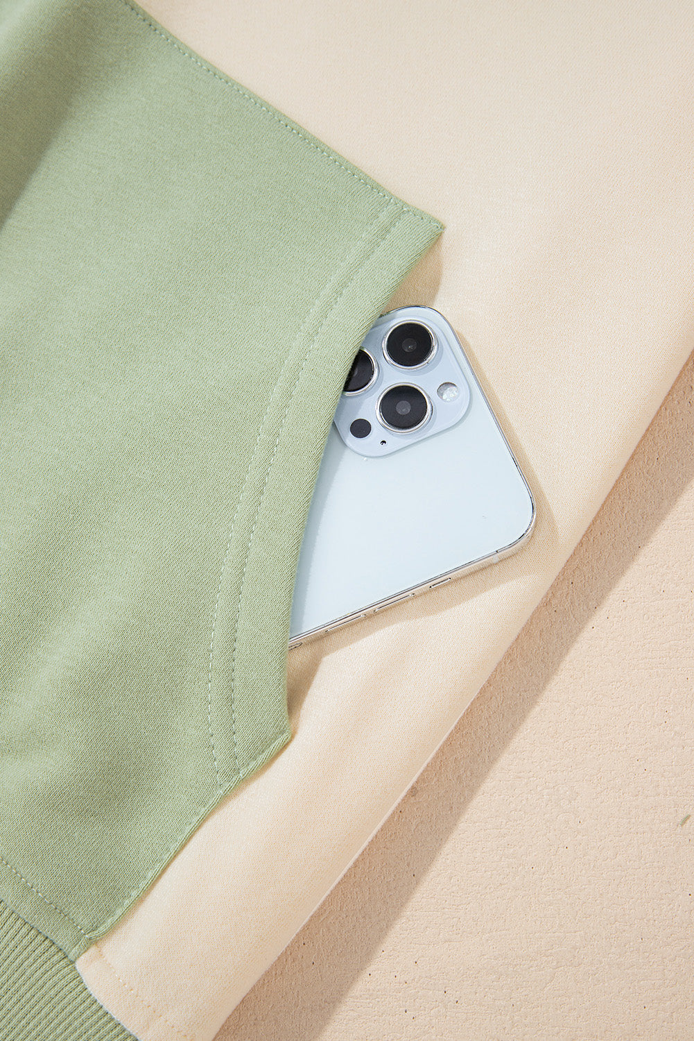 Laurel green colorblock patchwork sweatshirt with buttoned collar and kangaroo pocket