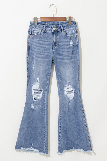 Dusk blue high-waisted flared jeans with distressed hem and ripped details