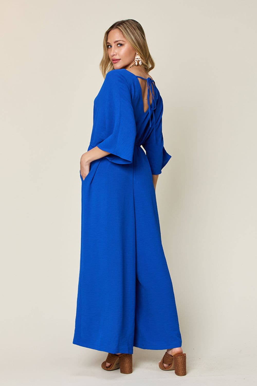 Double Take Full Size Surplice Wide Leg Jumpsuit with Pockets.