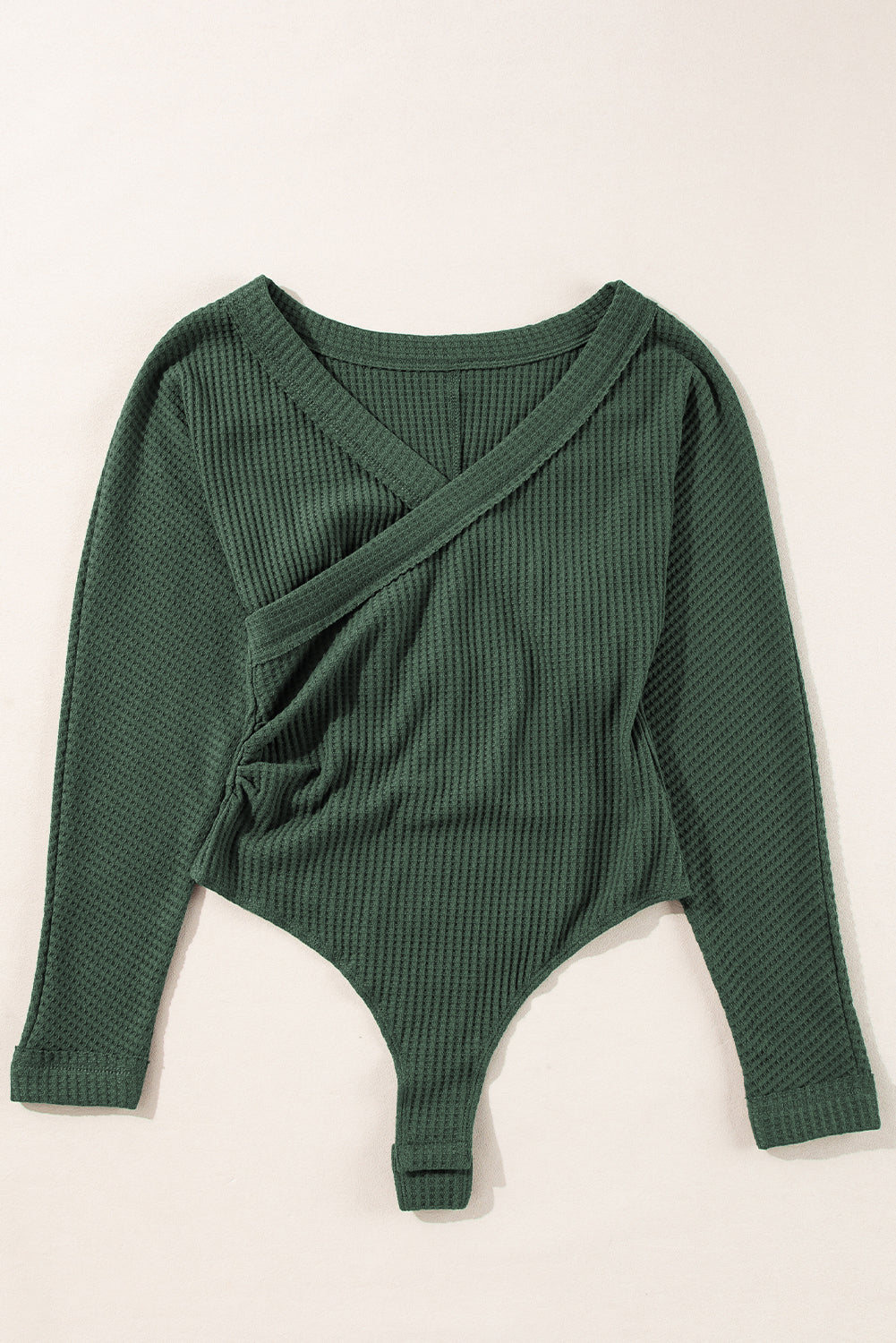 Chic blackish green ribbed bodysuit with wrap V-neck design.